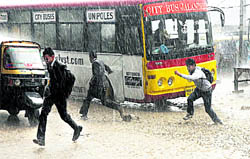 Schoolboys run for cover as heavy rain pours down in Jalandhar on Tuesday
