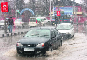 Motorists have a tough time crossing the waterlogged Regal Chowk in Srinagar after a spell of rain.