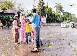 Children enjoy afternoon showers in Dehradun on Wednesday. 