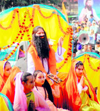 Devotees take part in a procession on the eve of the birth anniversary of Guru Ravidas in Jammu on Wednesday