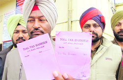 Ladhowal SHO Jatinder Singh shows fake toll slips in Ludhiana on Wednesday. 