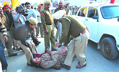 Cops take away Asha Rani from outside the Sports Stadium in order to thwart her attempt to protest before Deputy Chief Minister Sukhbir Singh Badal, who was in Bathinda on Thursday. Tribune photo: Pawan Sharma