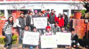 Students of University Business School in front of chairperson Dinesh Gupta’s house in Chandigarh on Thursday.