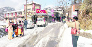 A tourist clicks a photograph of his relatives in Mussoorie on Thursday.  