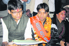 Rohtak MP Deepender Hooda and yoga bronze medallist Bharat Kumar at a function at Sikandurpur village in Jhajjar district.