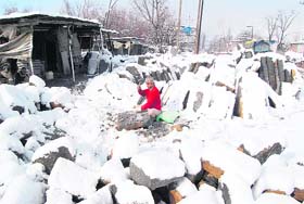 Heavy snow does not deter this man from cutting stones in Pulwama