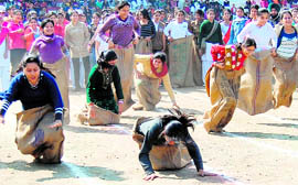 Girls of the BBK DAV College participate in a sack race during the sports meet in Amritsar.
