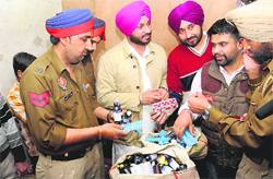 Police officials examine the habit-forming drugs found during a drive conducted by activists of the Punjab Youth Congress at Nayagaon, near Chandigarh, on Friday.