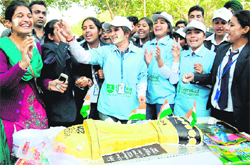Jubilant students wish the Indian cricket team luck by cutting an 11-kg trophy-shaped cake in Sector 17, Chandigarh, on Friday. 