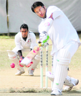 A batsman plays a eyes-shut-tight shot during a match in the Beehive Challenge Cricket Challenger Tournament in Dehradun on Friday.