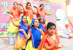 Girls perform during a function on the birth anniversary of Guru Ravidass in Jammu