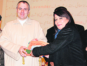 Chief Minister Omar Abdullah honours Dr Gazalla Aminat at a function held at the Sher-i-Kashmir International Convention Centre in Srinagar.