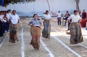 Students participate in a sack race during the athletic meet of the SSD Girls College in Bathinda