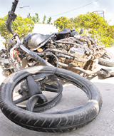 The mangled remains of the motorcycle that was hit by a mini-truck (right) on the Ramgarh-Panchkula road on Friday night.
