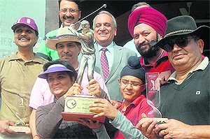 Winners strike a pose with their trophy in the Rotary District Golf Tournament at Chandigarh on Sunday.