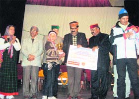 Govind Singh Thakur, MLA, distributes prizes to the ski winners at Harnam Singh Auditorium at Manali