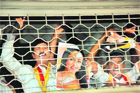 Members of Kannada Rakshan Vedike hold a photograph of actor and BJP leader Hema Malini and shout slogans against BJPs decision to field the actor for the Rajya Sabha seat from Karnataka, in Bangalore on Sunday