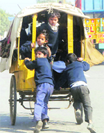 Burdensome years: Schoolchildren push a rickshaw inviting danger in Chandigarh