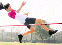 A participant tries to cross the bar in the high jump event during the annual athletics meet at YPS, Mohali,