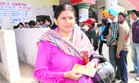 A woman shows a ticket of the ICC World Cup league match outside the PCA Stadium in Mohali.