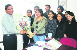 Students of University Business School welcome chairperson Dinesh K Gupta