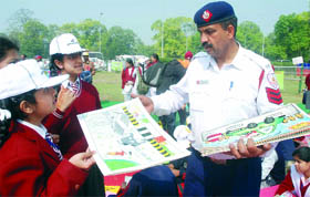 Schoolchildren submit their paintings during a competition organised by the Delhi police at the India Gate lawn in New Delhi on Monday.