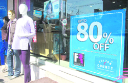 A shop with a poster of discount offer in Dehradun.