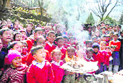 Young students watch a demonstration at a science mela at Bachhuaban village in Chamoli district. 