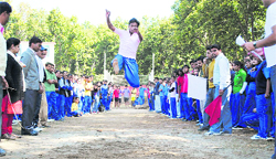 A student takes part in the long jump event during the annual week of Dolphin (PG) Institute of Bio-medical and Natural Sciences in Dehradun on Monday. 
