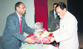 Chairman of ICL Group of Colleges honours AD Gandhi (right), chairman of Haryana Chamber of Commerce and Industry, at SD College, Ambala Cantt.