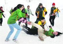 Tourists play rugby during the snow festival at Gulmarg on Monday. 