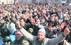 Members of the Employees Joint Action Committee protest in Srinagar on Monday. 