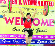 A participant lifts weight during the District Weightlifting Championship in Ludhiana on Monday.