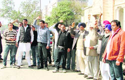 Panchayat members of Narangwal village protest against the Khanna police for booking a youth in a criminal case, outside the DIG’s office in Ludhiana on Monday.