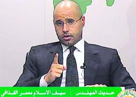 Saif al-Islam, son of Libyan leader Muammar Gaddafi, gestures as he speaks during an address on state television in Tripoli