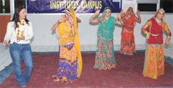 A Rotarian from Venezuela joins students performing a Rajasthani folk dance during a visit to Sriganganagar.