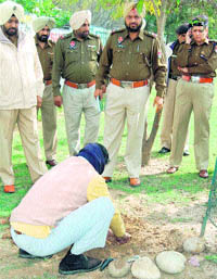 A caretaker of a garden searches for a childs body, which later turned out to be a dogs carcass, in Mohali on Tuesday.