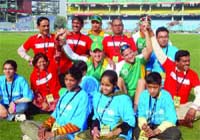 South African cricket captain Graeme Smith (C) and teammates pose with HIV-affected people during a campaign of the ICC and the UN, ThinkWise, at Ferozeshah Kotla Stadium in New Delhi