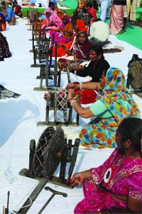 Women participate in Charkha Yagya on the occasion of the death anniversary of Kasturba Gandhi at Gandhi Smriti in New Delhi