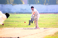 A batsman tries to defend the ball at the Dayanand Stadium in 