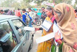 Family members of shopkeepers beg as a mark of protest in Dehradun