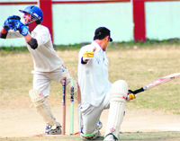 The wicketkeeper appeals for a stumping in a match of the 60th District Cricket League at the Survey of India stadium, Hathibarkala, on Tuesday. A Tribune photograph