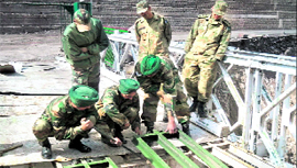 Army personnel repair Aman Setu near Uri on the Srinagar-Muzaffarabad road on Tuesday.