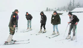 An Army instructor trains youngsters in skiing at High Altitude Warfare School in Gulmarg.