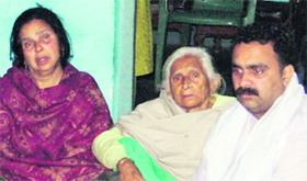 The victims wife (left) grieves with her family. Photo: Inderjeet Verma