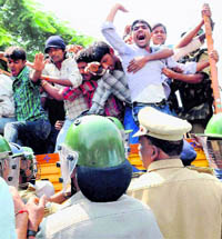 The police detains students of Nizam College during their protest for a separate Telangana state in Hyderabad. Normal life came to a grinding halt in the Telangana belt on Tuesday