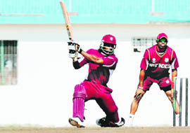West Indies Chris Gayle (L) is watched by teammate Dwayne Bravo (R) as he bats during a training session in New Delhi on Wednesday.
