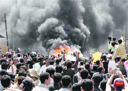 Anti-government protesters set a car belonging to government supporters on fire outside Sanaa University on Tuesday