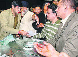 Action packed: Superintendent of Police Manish Chaudhary (left) talks to shopkeepers while a trader shows his bleeding hand at the Sector 7 market in Panchkula on Wednesday.