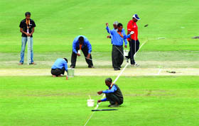 Workers give a finishing touch to the grounds on the eve of South Africa-West Indies match in New Delhi on Wednesday.